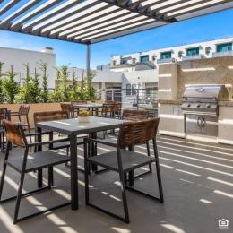 outdoor patio and grilling area with chairs and tables