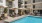 a pool with chairs and umbrellas