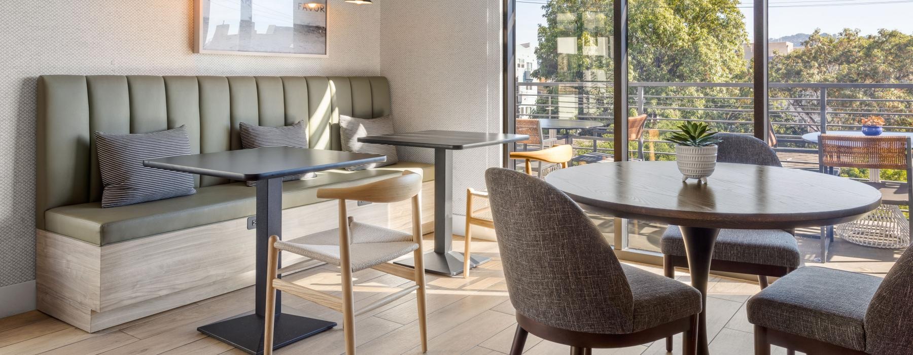 a room with a table chairs and a window