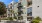 a building with balconies and plants in front of it